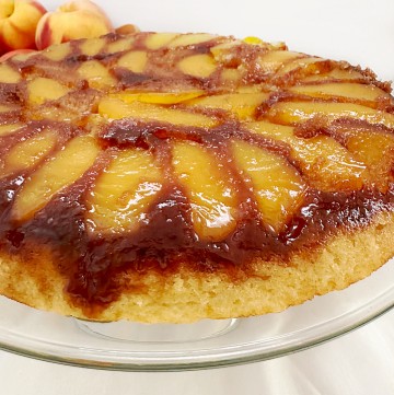peach upside down cake on serving plate