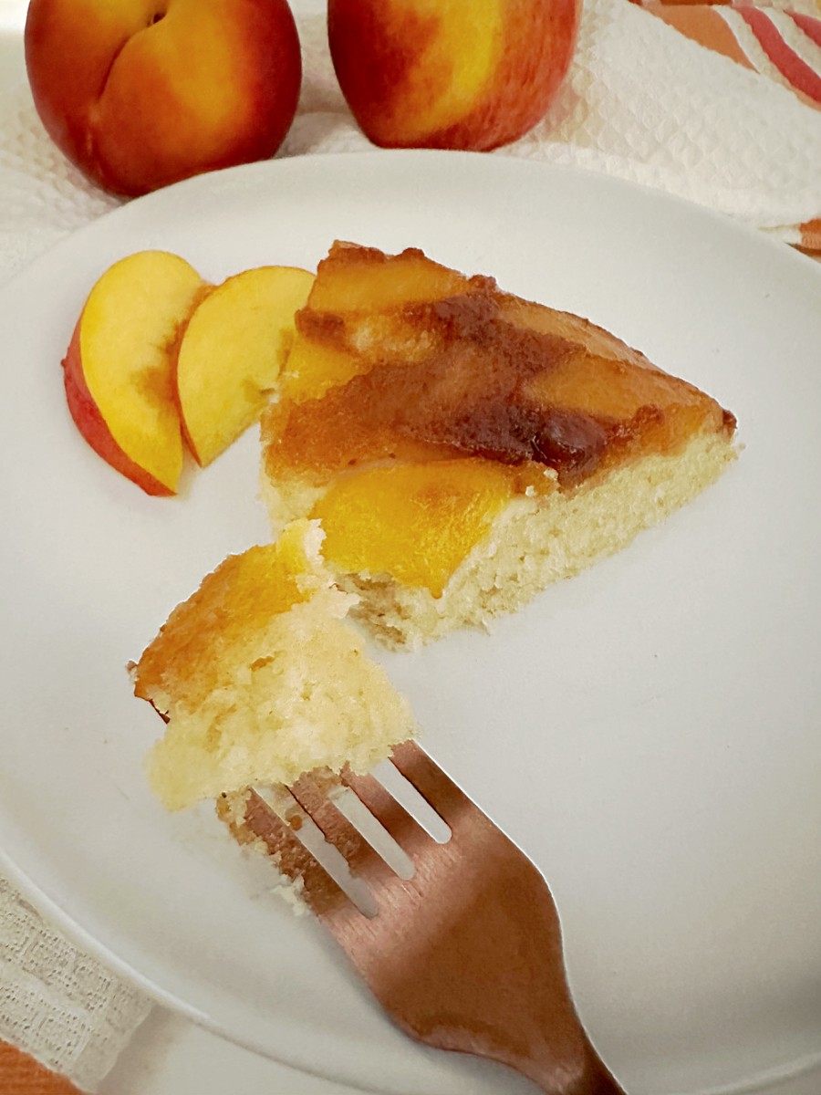 peach upside down cake slice on white plate