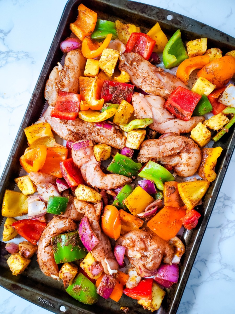 spread chicken and vegetables on pan