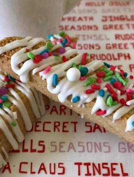 Italian Anise Biscotti gets a festive holiday makeover with colorful sprinkles. Whether you dunk this twice-baked cookies into your coffee or tea, or simply enjoy them as a treat, you'll get that classic anise flavor in each bite with bonus white chocolate drizzle. #ChristmasSweetsWeek #ad #biscotti #cookies #anise #Christmas #sprinkles