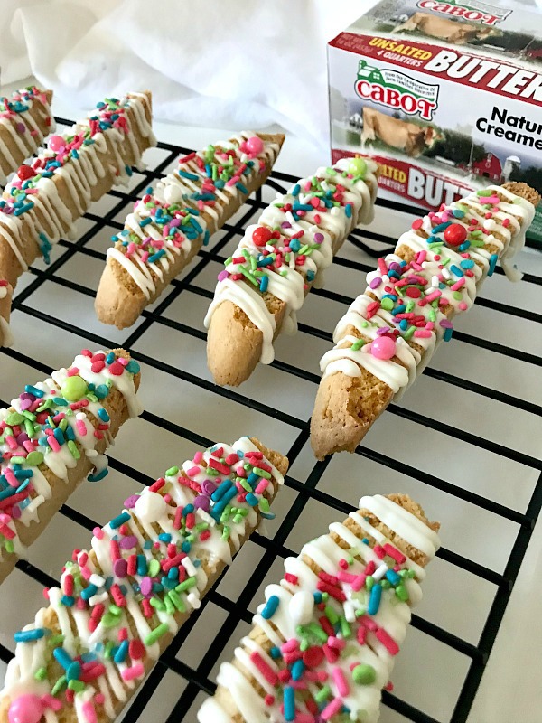 Italian Anise Biscotti gets a festive holiday makeover with colorful sprinkles. Whether you dunk this twice-baked cookies into your coffee or tea, or simply enjoy them as a treat, you'll get that classic anise flavor in each bite with bonus white chocolate drizzle. #ChristmasSweetsWeek #ad #biscotti #cookies #anise #Christmas #sprinkles 