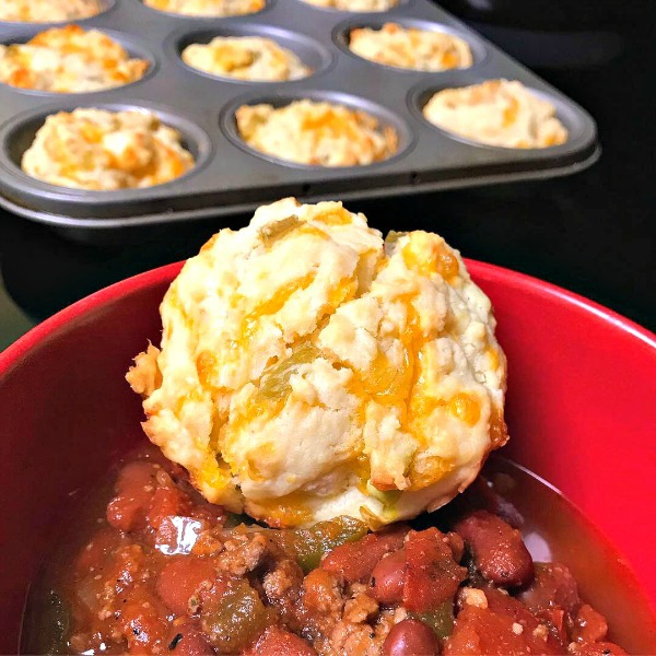 These tasty cheesy chili muffins are baked with sharp cheddar cheese and green chiles and are perfect to serve along side chili or a Tex-Mex meal. #cheese #muffins #chili #pinterestchallenge. 