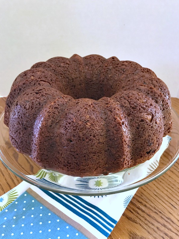 This German Chocolate Bundt Cake with a Homemade Coconut Frosting is moist, decadent, and does not disappoint. Perfect cake to celebrate any special occasion. #GermanChocolateCake #cake #chocolate