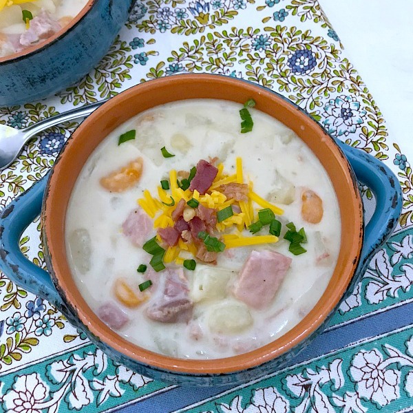 This Slow Cooker Creamy Potato and Ham Soup is hearty, delicious, and easy to make. Comfort food that is loaded with ham, potatoes, and veggies all slow cooked in a tasty and creamy broth. #slowcooker #crockpot #soup #potato #ham