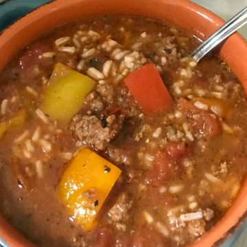 Slow Cooker Stuffed Pepper Soup is a hearty meal loaded with everything you love about a classic stuffed pepper - ground beef, rice and bell peppers, all in a tomato-based broth. #soup #stuffedpeppers #slowcooker #OurFamilyTable