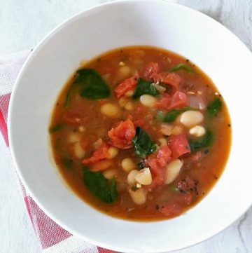 This vegan fire-roasted tomato and bean soup only takes 30 minutes to make, is full of flavor, and makes a great vegan weeknight meal.