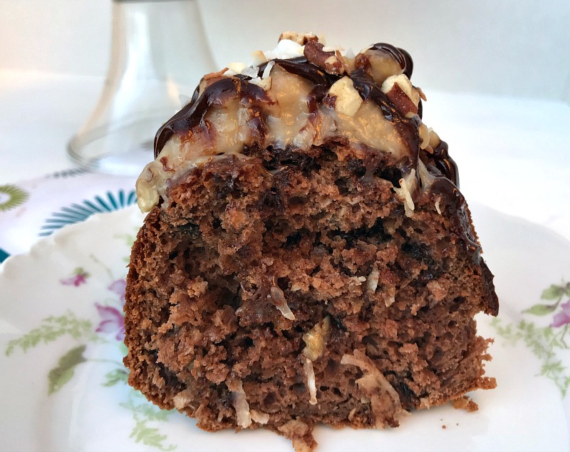 This German Chocolate Bundt Cake with a Homemade Coconut Frosting is moist, decadent, and does not disappoint. Perfect cake to celebrate any special occasion. #GermanChocolateCake #cake #chocolate