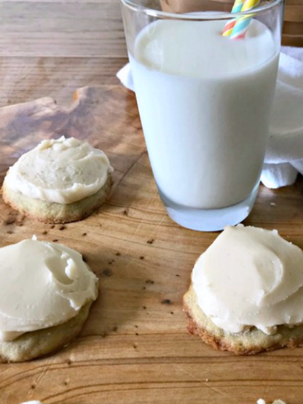 Frosted banana nut bread cookies and a glass of milk