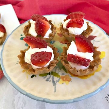 No Bake Mini Strawberry Cheesecake Cups on platter- feature