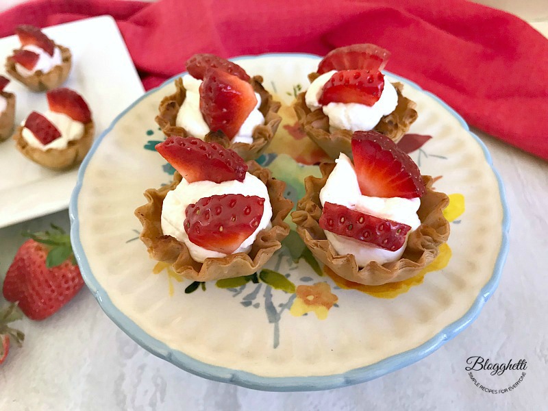 No Bake Mini Strawberry Cheesecake Cups on platter- feature