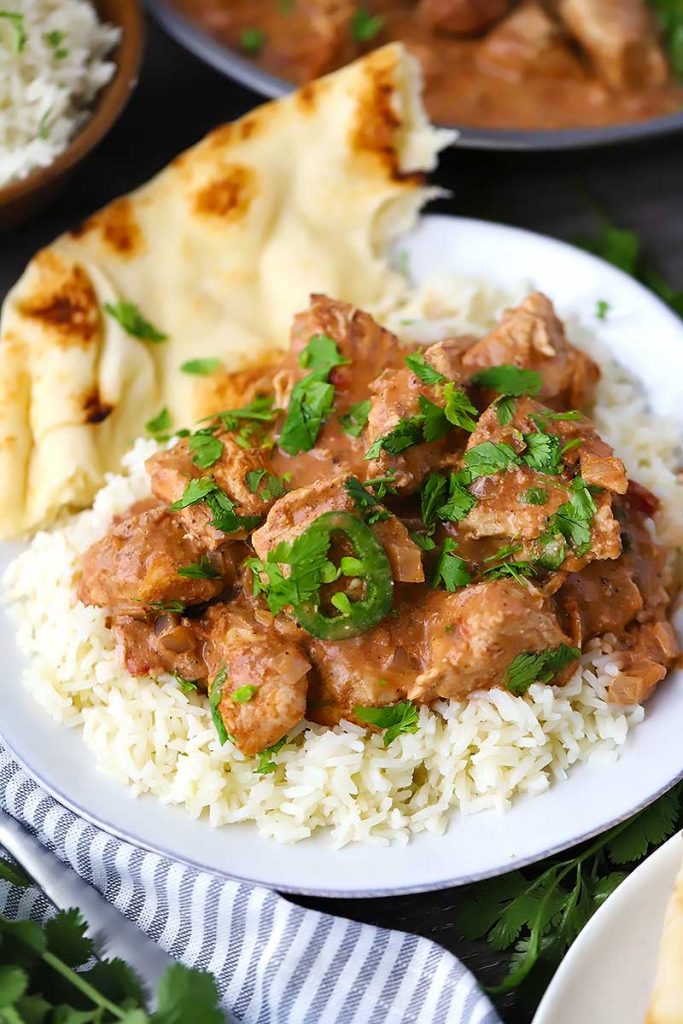 Easy-Chicken Tikka Masala served over rice on a white plate.