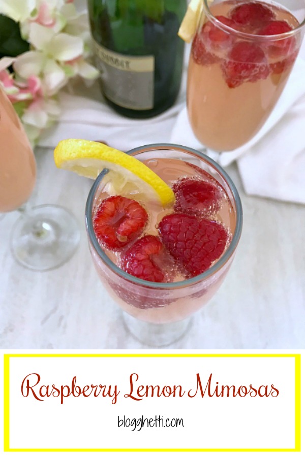 Raspberry Lemon Mimosas in champagne flutes with the fresh fruit in the glasses