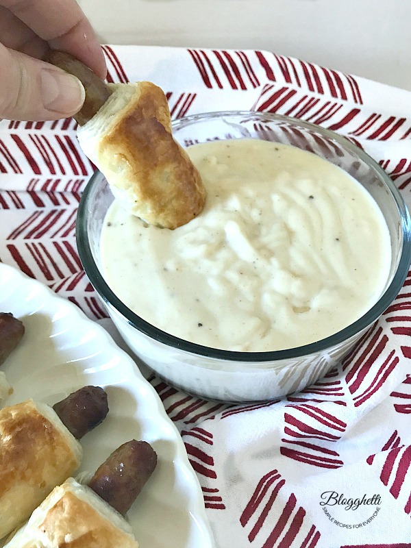 Sausage Dippers being dunked in white gravy