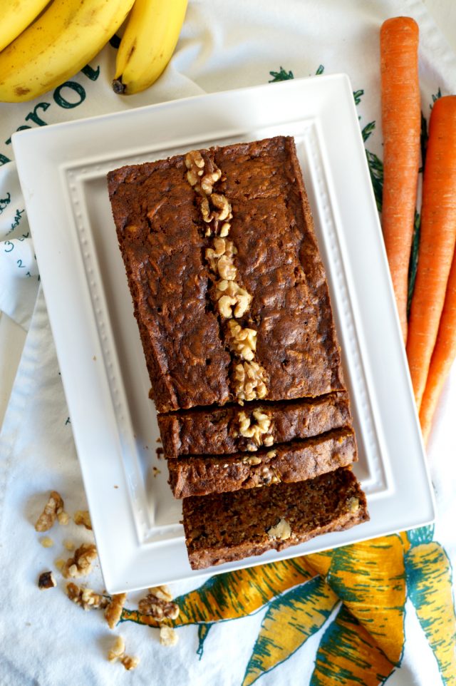 sliced loaf of Vegan Carrot Cake Banana Bread on a white plate