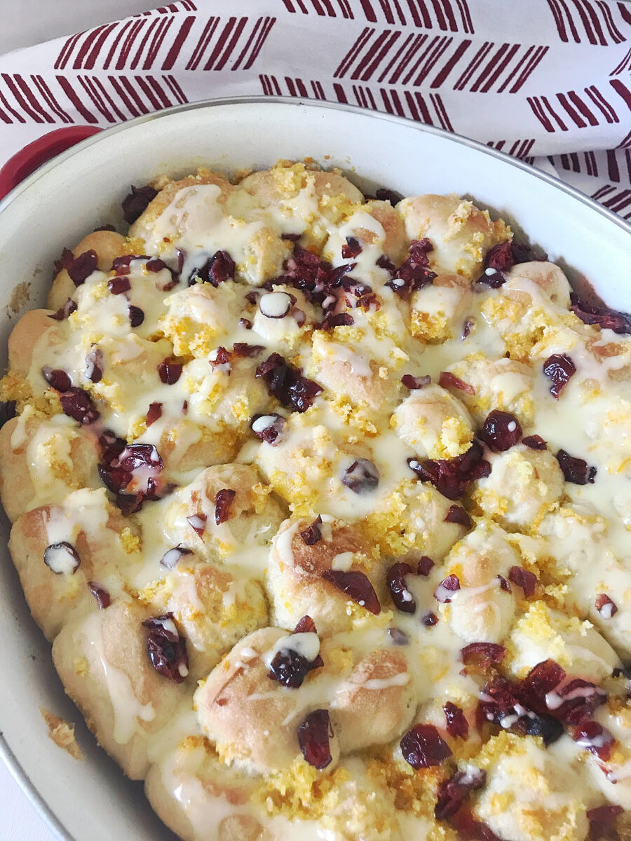 Warm pull-apart breakfast bread drizzled with sweet orange glaze and finished with dried cranberries.