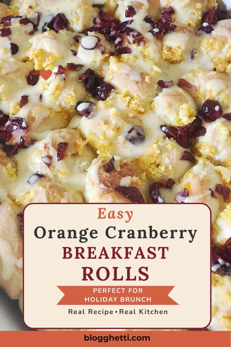 Pinterest graphic showing a close-up of glazed orange cranberry breakfast rolls with dried cranberries and orange sugar. An overlay reads "Easy Orange Cranberry Breakfast Rolls" with a banner that says "Perfect for Holiday Brunch.