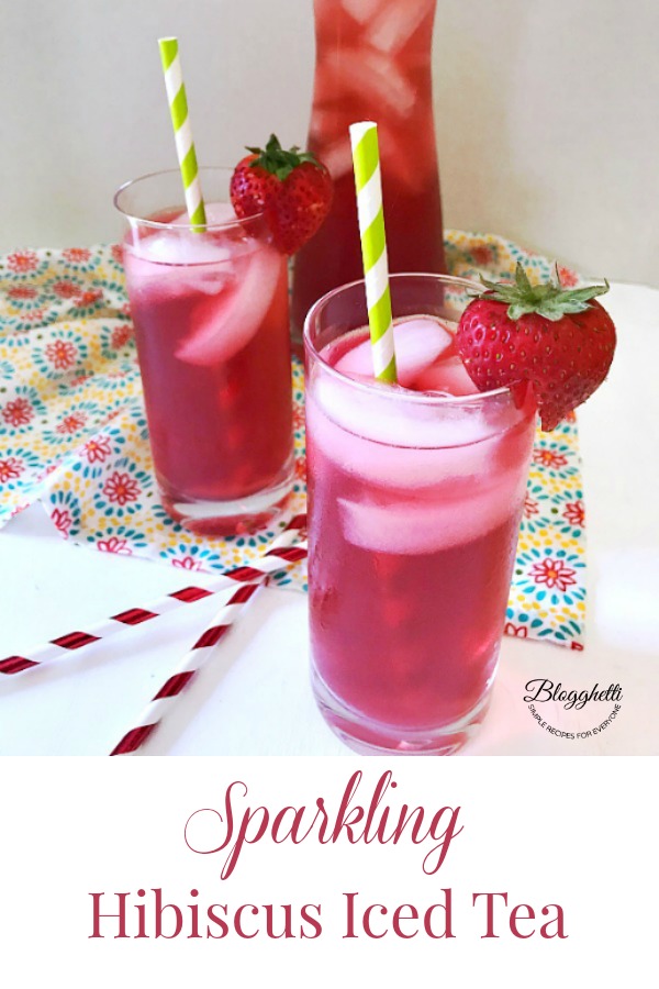 Sparkling Hibiscus Iced Tea in glasses garnished with straws and strawberries. #hibiscus #icedtea #tea #drinks