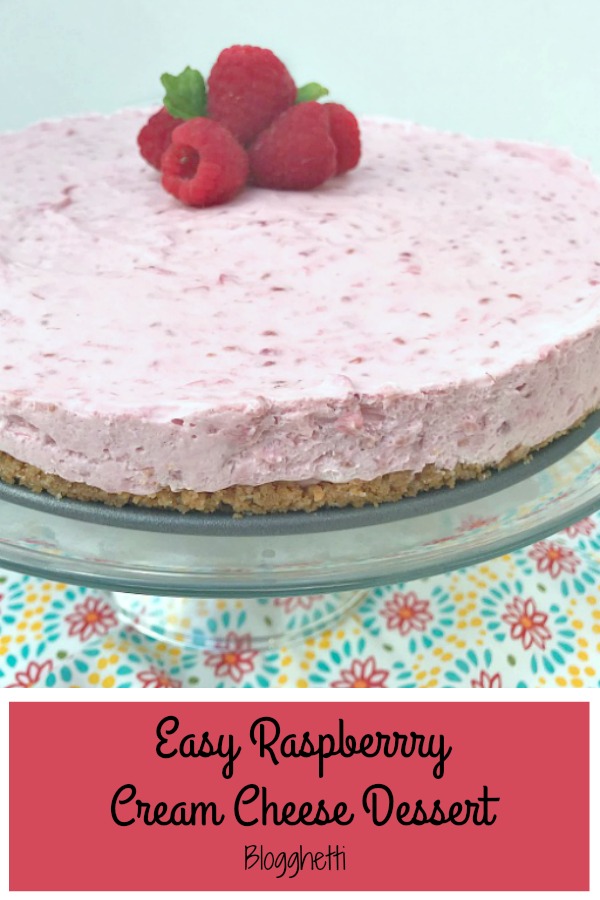 Easy Raspberry Cream Cheese Dessert on a dessert stand with fresh raspberries on top