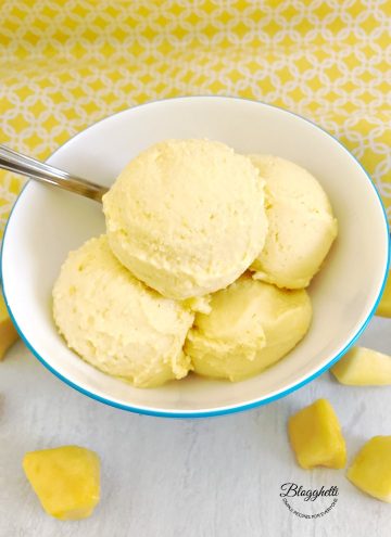 2-Ingredient Mango Sherbet in white and blue bowl with a spoon