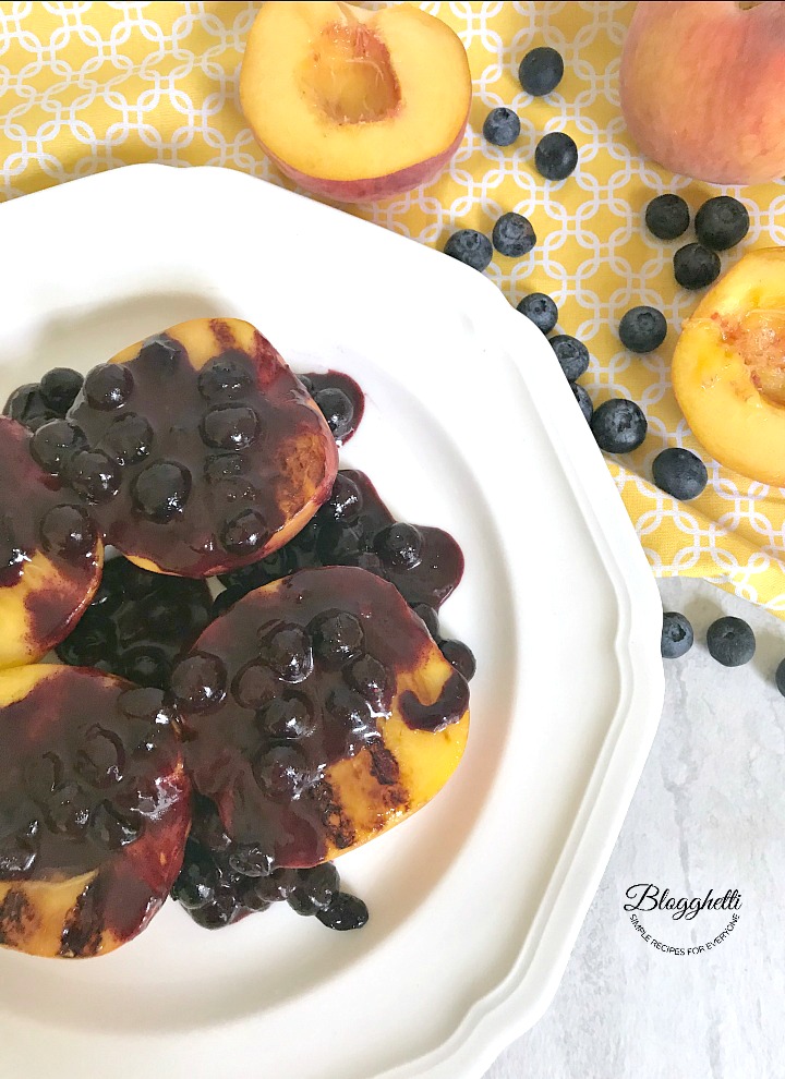 Grilled peaches with blueberry Syrup drizzled over them