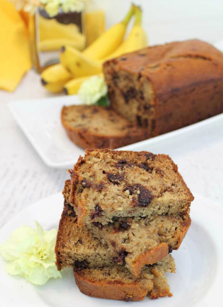 Stackof-banana-bread-slices-with-banana-bread-in-background-tall
