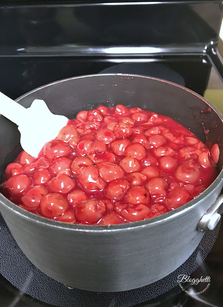 cherry pie filling simmering in saucepan