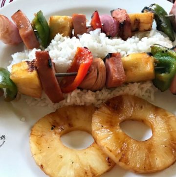Grilled Hawaiian Ham Skewers with rice and pineapple on a white plate
