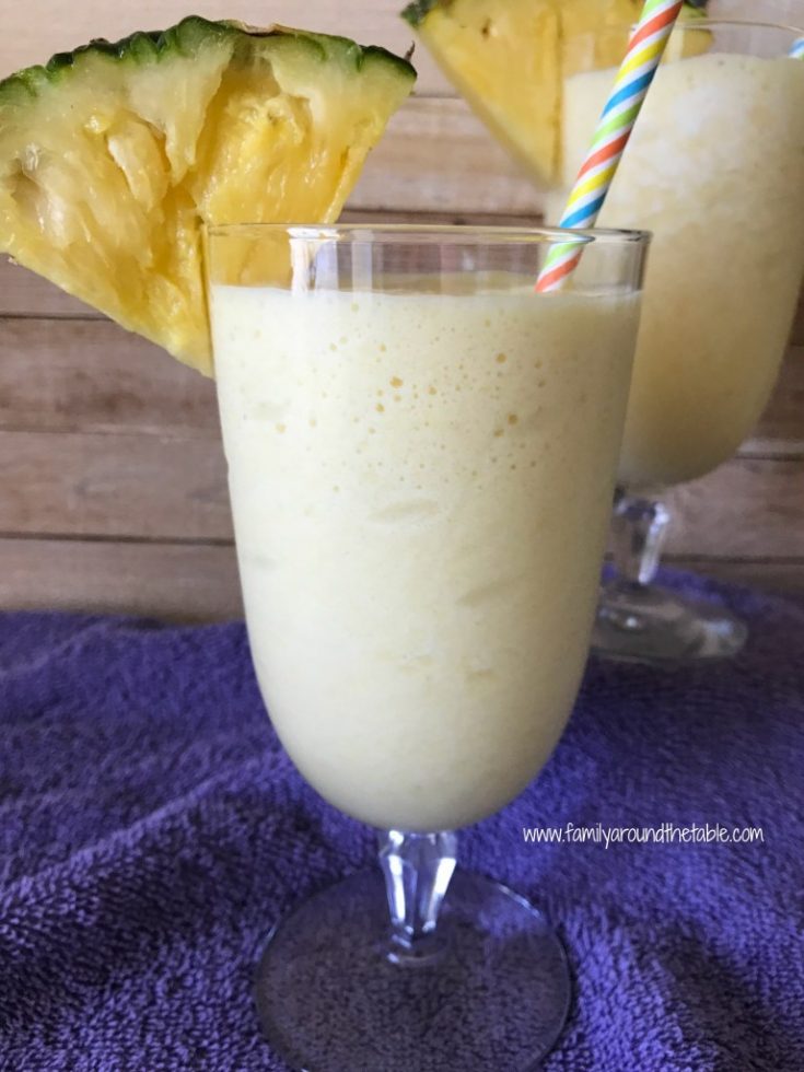glass filled with a pineapple orange breakfast shake