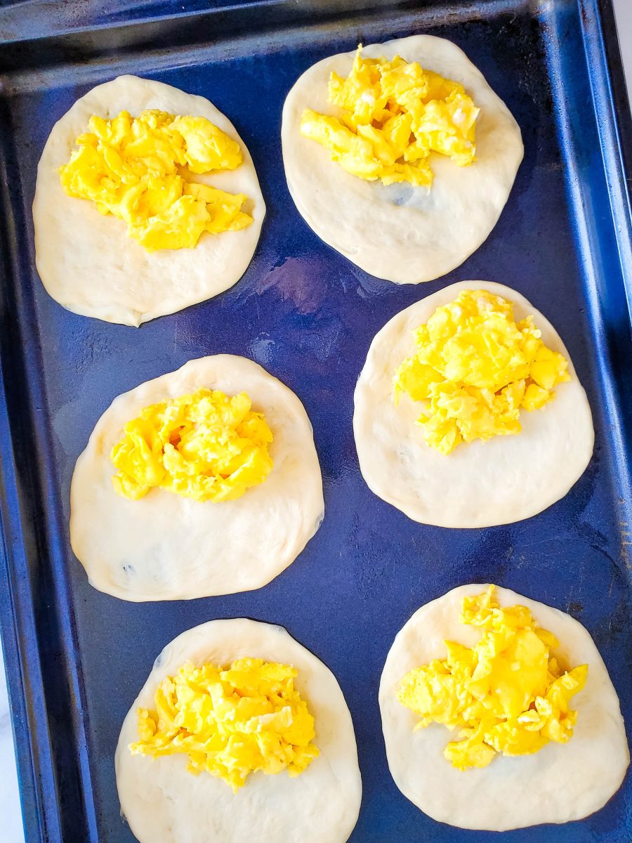 top the dough with some of the eggs