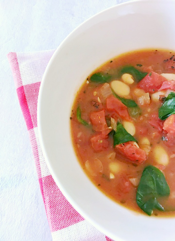 vegan fire roasted tomato and bean soup in white bowl