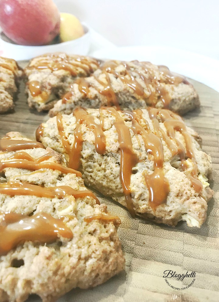 Caramel Apple Scones on a wooden platter with bowl of apples in the background