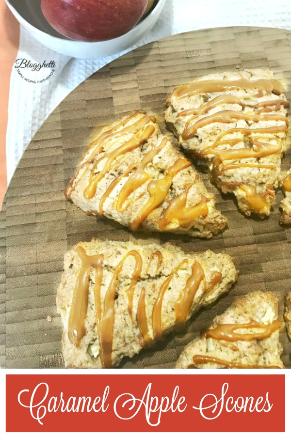 Caramel Apple Scones on a wooden platter with bowl of apples in the background