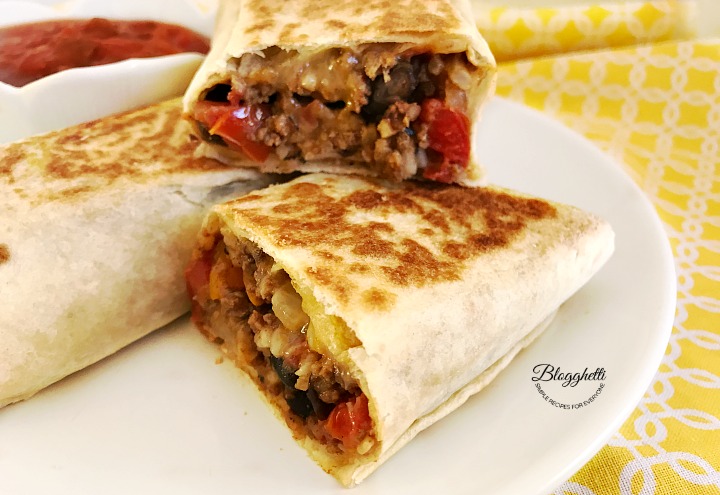 Crispy Southwestern Roll Ups on white plate with bowl of salsa