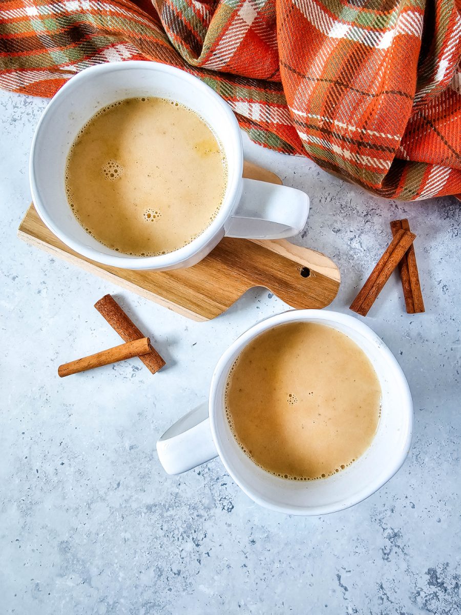 pour hot chocolate with pumpkin into mugs