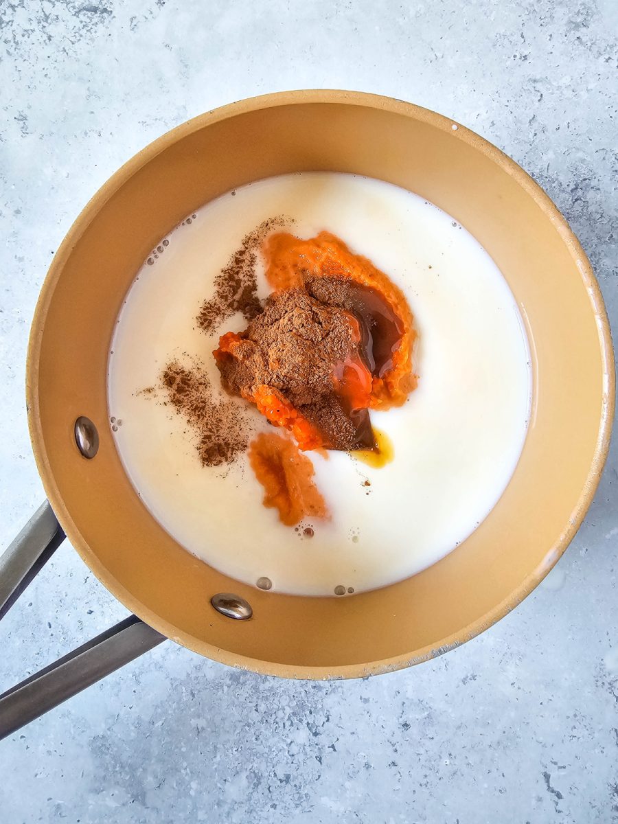 saucepan with milk pumpkin and spices