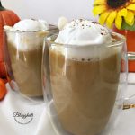 two glasses of pumpkin spice hot chocolate with whipped cream on top