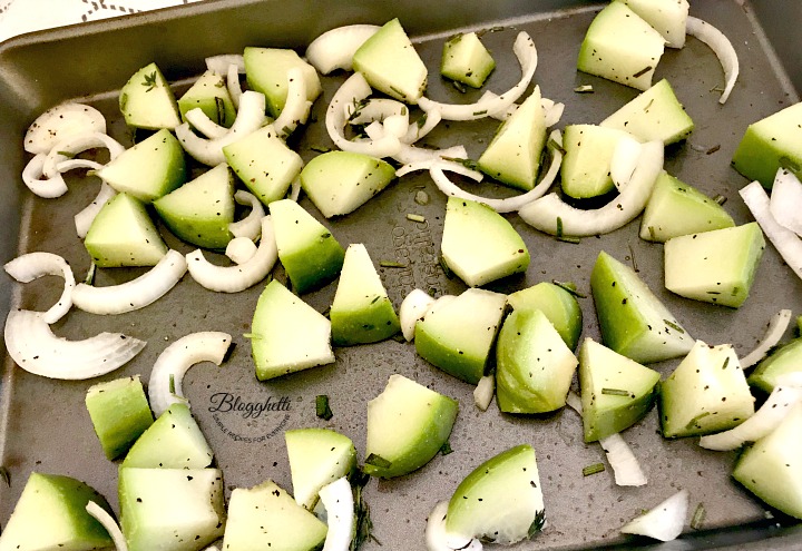 Chayote Squash and onions on sheet pan ready to roast