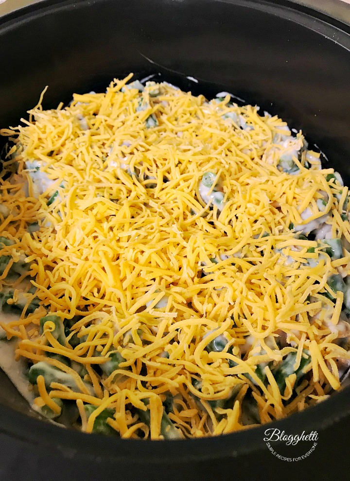 adding an extra cheese layer to the green bean casserole in the slow cooker