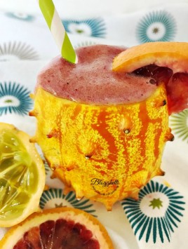 kiwano melon and blood orange smoothies in kiwano shell - close up