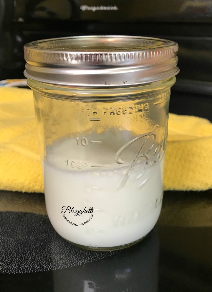 milk in mason jar ready to steam and froth