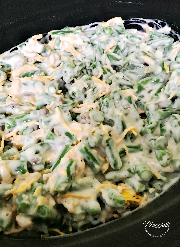 prepping the cheesy green bean casserole in the slow cooker