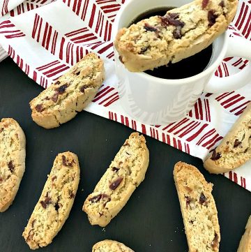 Cranberry Almond Biscotti and cup of coffee on a red-white towel