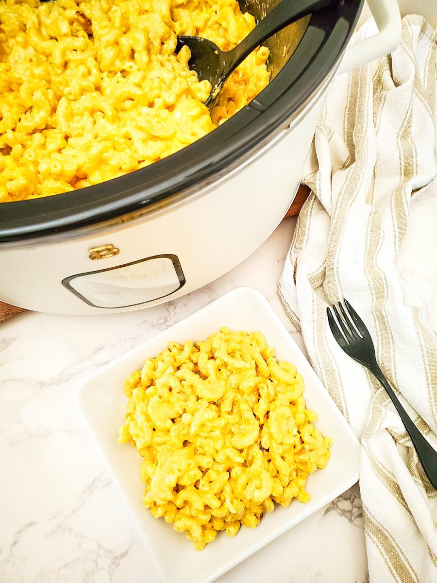 overhead shot of slow cooker and plate with mac and cheese