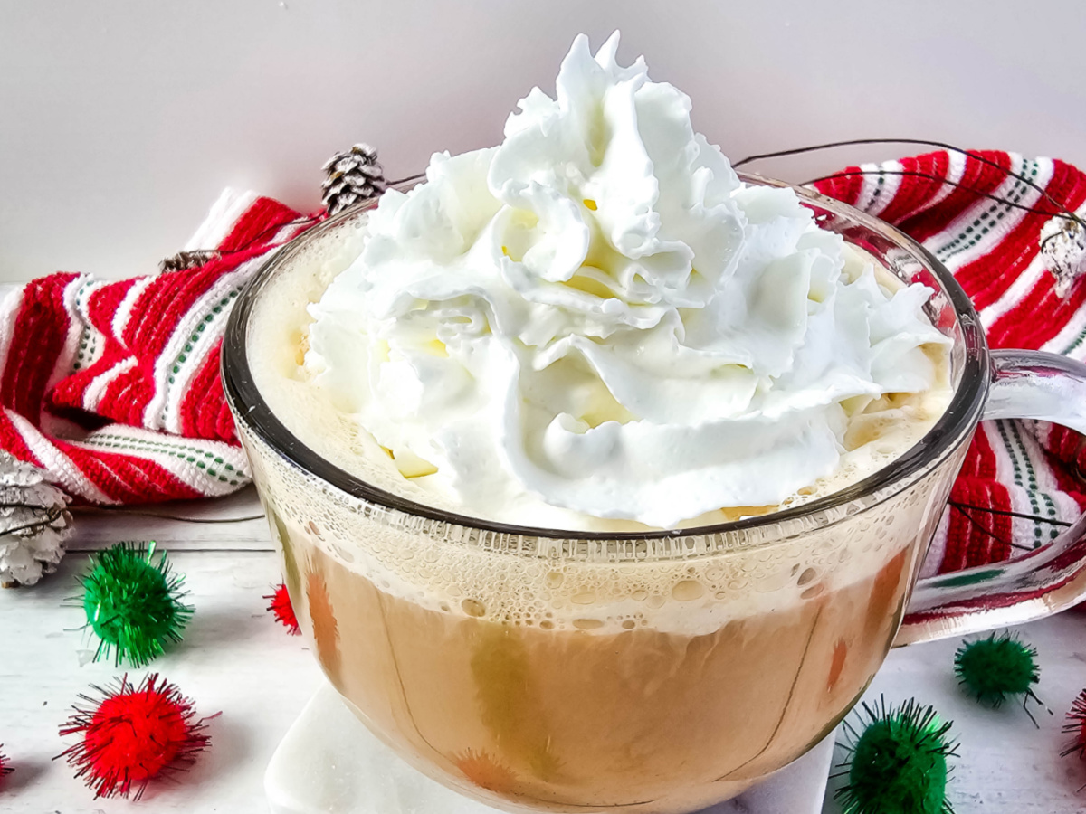 serve latte with whipped cream in mug