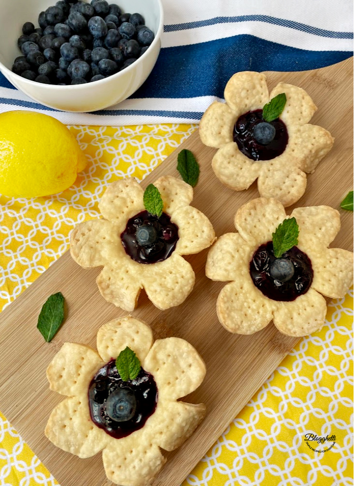 Blueberry Flower Tarts on wooden platter