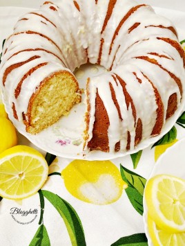 Lemon Bundt Cake with Lemon Glaze #SpringSweetsWeek Easy Lemon Bundt Cake with Lemon Glaze with slice taken out