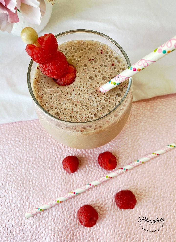 Raspberry almond coffee smoothie in clear glass