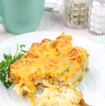a serving of breakfast casserole on white plate with a fork