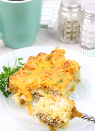 a serving of breakfast casserole on white plate with a fork