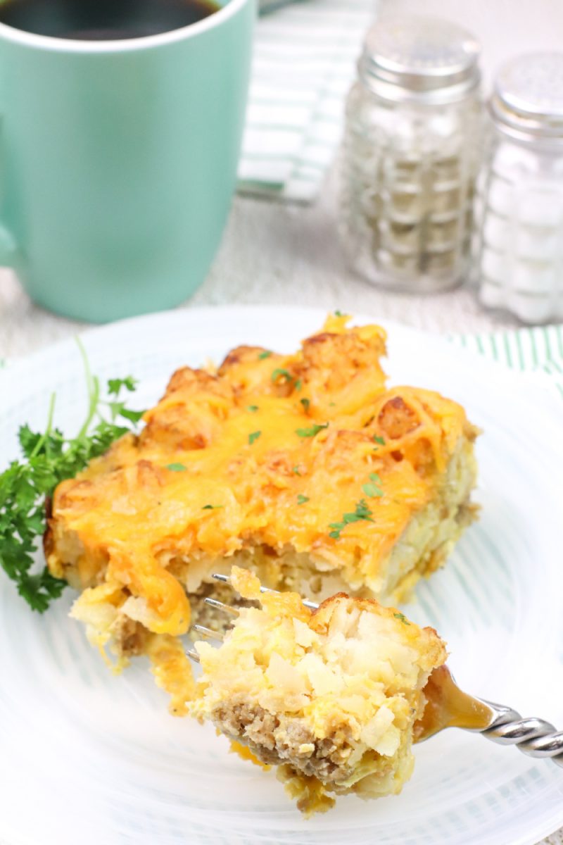 a serving of breakfast casserole on white plate with a fork